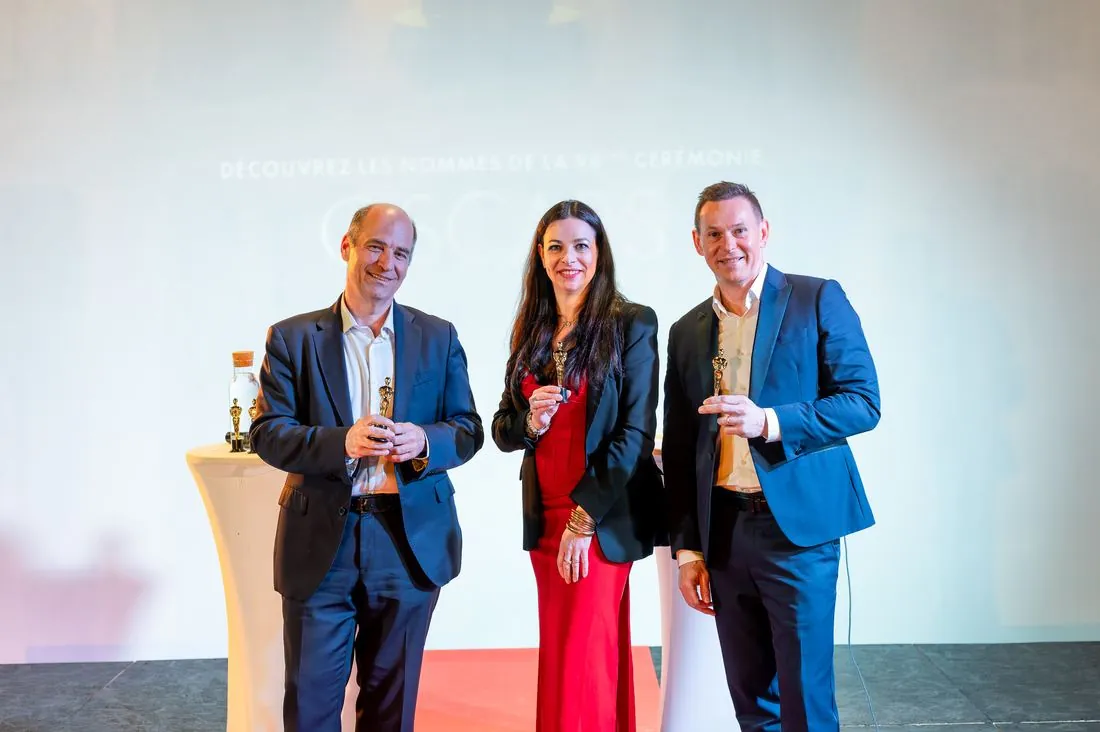 Trois lauréats en tenue de soirée lors d’une remise de prix
